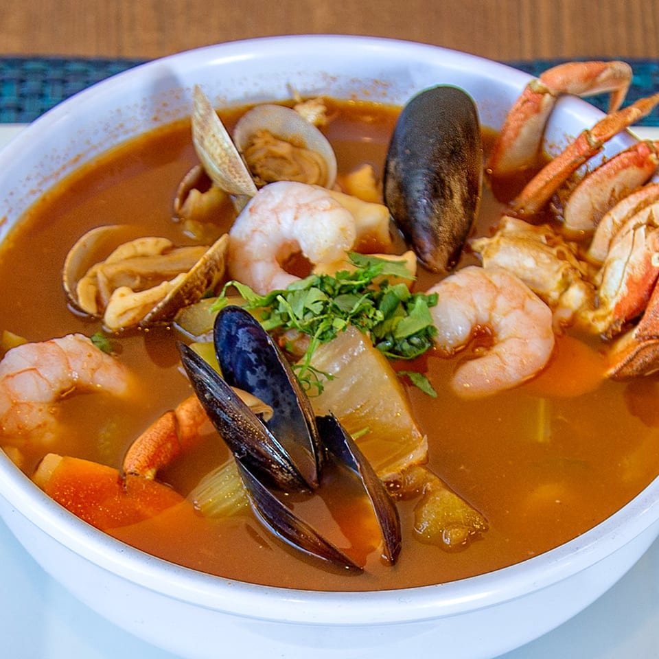 A close-up of Ruben's Mariscos and Mexican Grill's seafood soup with shrimp, mussels, clams, and crab.