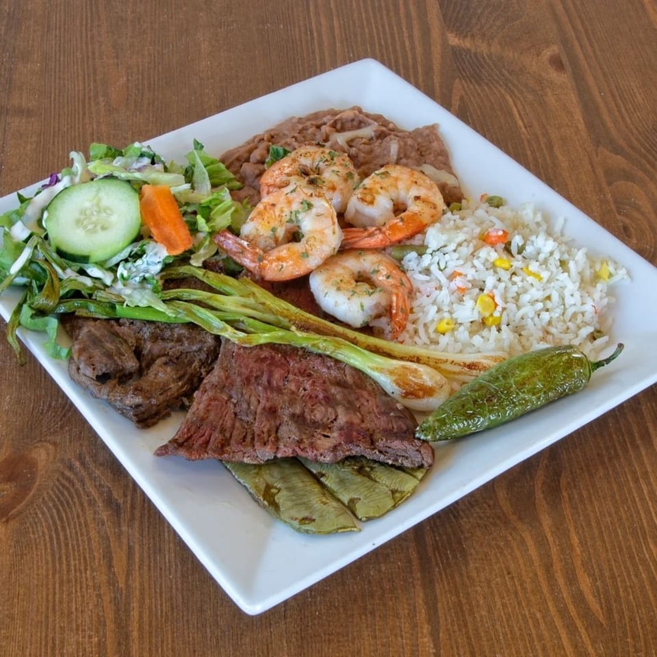 Ruben's Mariscos and Mexican Grill's Mexican dish with steak, shrimp, rice, beans, salad, and a pepper.