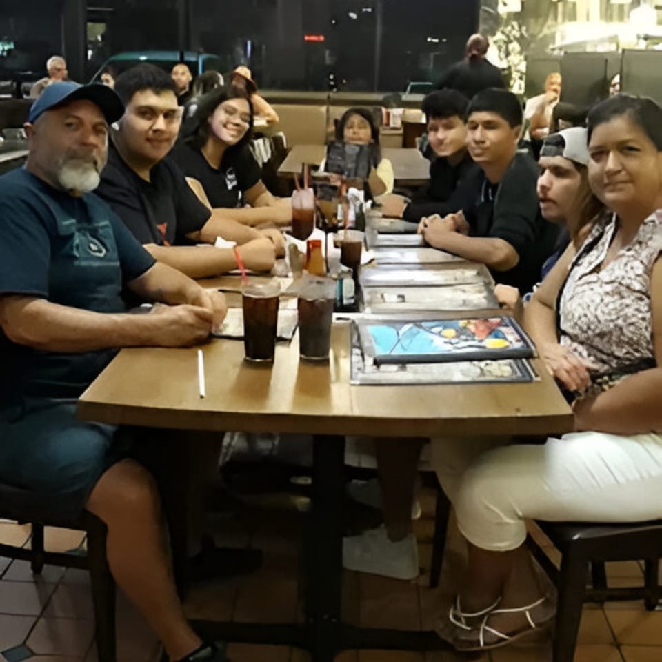 A large family group seated around a table at Ruben's Mariscos and Mexican Grill.