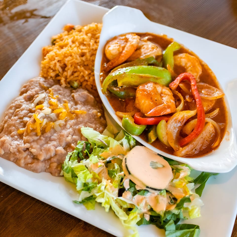 Ruben's Mariscos and Mexican Grill's shrimp fajitas with rice, refried beans, and a side salad.